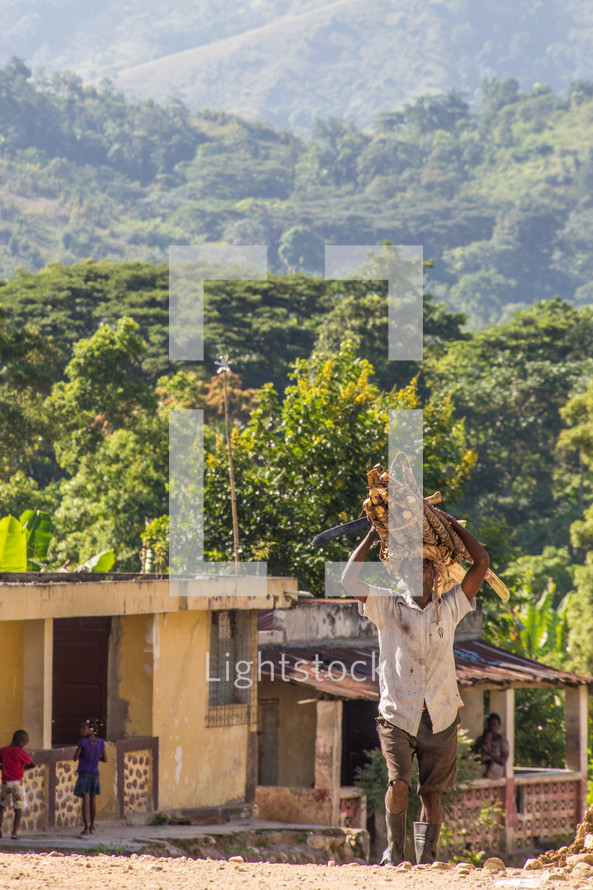 a man carrying wood in Haiti 