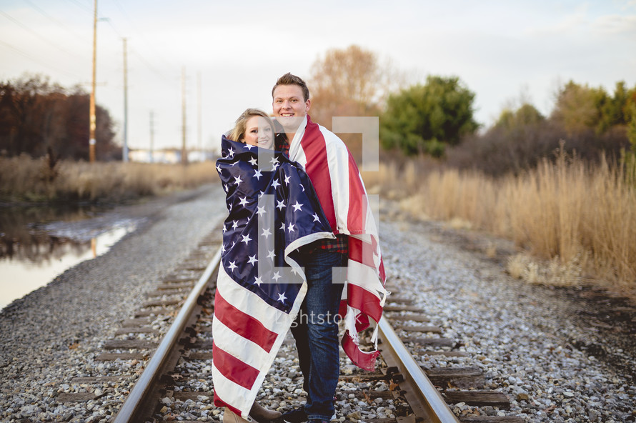 couple wrapped in an American flag 