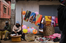 Street vendor selling fabrics and shoes