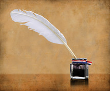 A feather quill pen dipped in an inkwell.