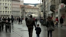 People walking in a courtyard in Trieste, Italy