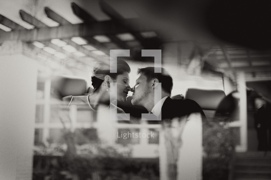 reflection of a bride and groom kissing