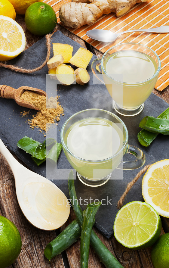 Drink with aloe vera and lemons. Glass cups on a slate tray