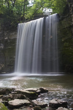 A slow shutter speed to emphasize the flow of a waterfall.