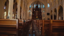 Inside the new church with quiet pews. Wide shot