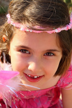 little girl with missing teeth dressed like a princess