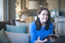 woman holding a bible and talking at a Bible study