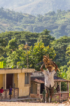 a man carrying wood in Haiti 