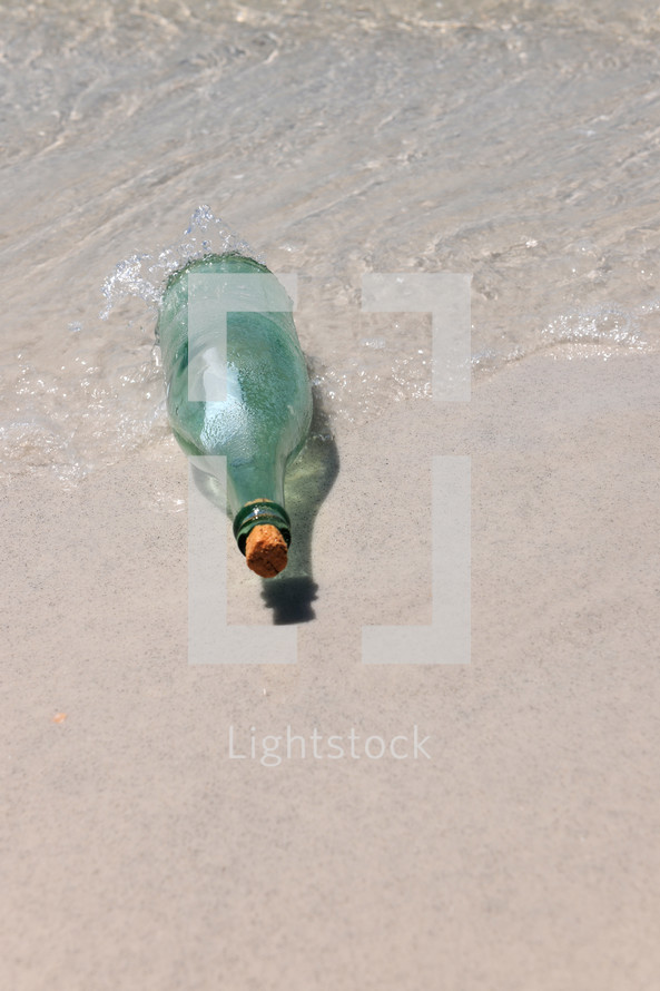 Message in a bottle on a beach.