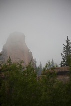 fog over rock formations in the wilderness 