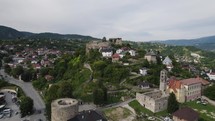 Jajce's Citadel Amidst Town and Hills, Aerial wide view. Bosnia and Herzegovina