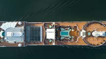 Passenger cruise ship sailing in ocean top view from above. 