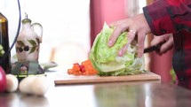 a man cutting lettuce 