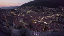 Croatia Aerial: Dubrovnik at dusk, highlighting terracotta rooftops and mountain backdrop