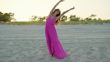  Girl in pink dresses Dance On The Sand At Sunset vacation