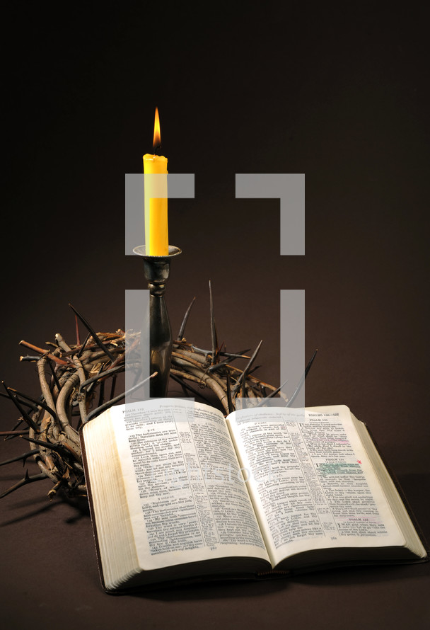 crown of thorns, candle, and opened Bible 