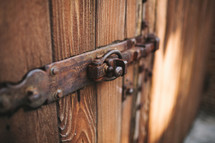 lock and hinge on a wooden door