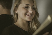 woman smiling holding a Bible 