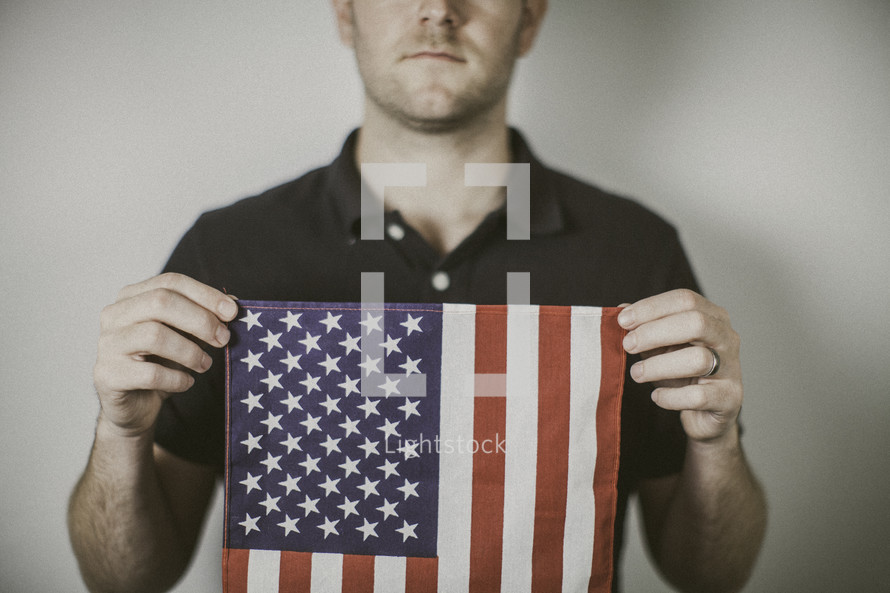 man holding an American flag 