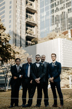 groom and groomsmen portrait in a city 