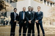 groom and groomsmen portrait in a city 