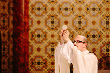 priest giving communion 