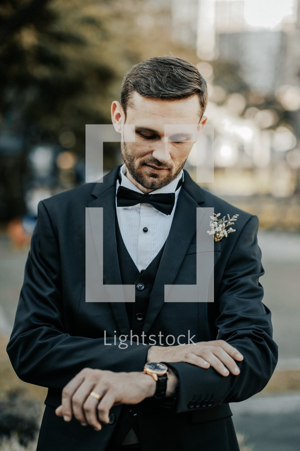 a groom looking at his watch 