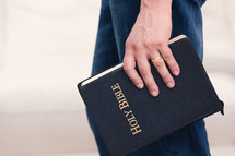 a man carrying a Bible at his side 