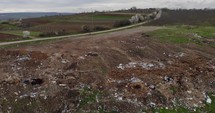 Aerial drone shot of Huge Countryside Landfill With Farmland. 