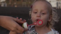 Little kids love blowing bubbles