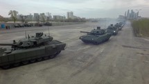 Aerial shot of tanks in columns setting off from military base, Russia
