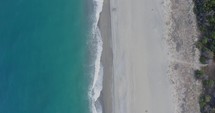 Overhead view of calm empty ocean waves near the beach