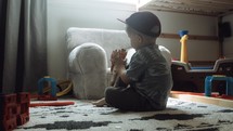 toddler boy playing with a dinosaur 