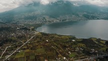 San Pablo Lake And Imbabura Volcano On A Cloudy Day In Ecuador - drone shot	