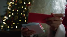 Santa Claus searching Through Christmas letters 