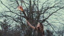  woman holding up a burning torch 