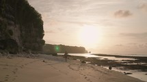 Man Running on Beach Sand Barefoot during Sunset Slow Motion