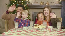 A family sitting at a table at Christmas 
