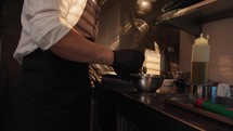 Chef Mixing ingredients in a kitchen of an hotel restaurant