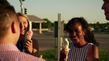 friends eating ice cream on a summer evening 