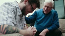 elderly man mentoring a young man 
