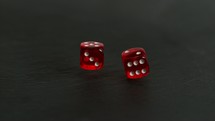 rolling dice on slate background.
