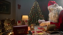 Santa Claus working under the Christmas tree 