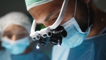 Cardiac Surgeon with surgical headlamp operates at a Heart Stent