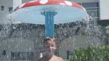 A boy taking an outdoor shower
