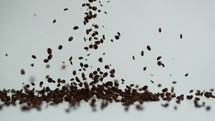 falling coffee beans on white background.