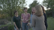 group of women talking outdoors 
