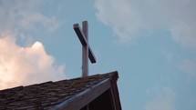 Cross against a partly cloudy sky