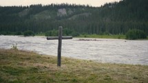 Old Wooden Cross Next To A River
