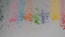 falling colorful powder on light background